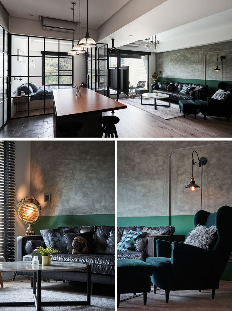 In this living room, a mottled stone wall texture shares the wall with a painted green stripe that covers the lower section of the wall. #LivingRoom #OpenPlanInterior #Apartment