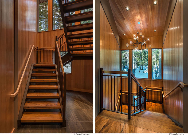 These wood and steel stairs are highlighted by a chandelier. #ModernStairs #StairDesign