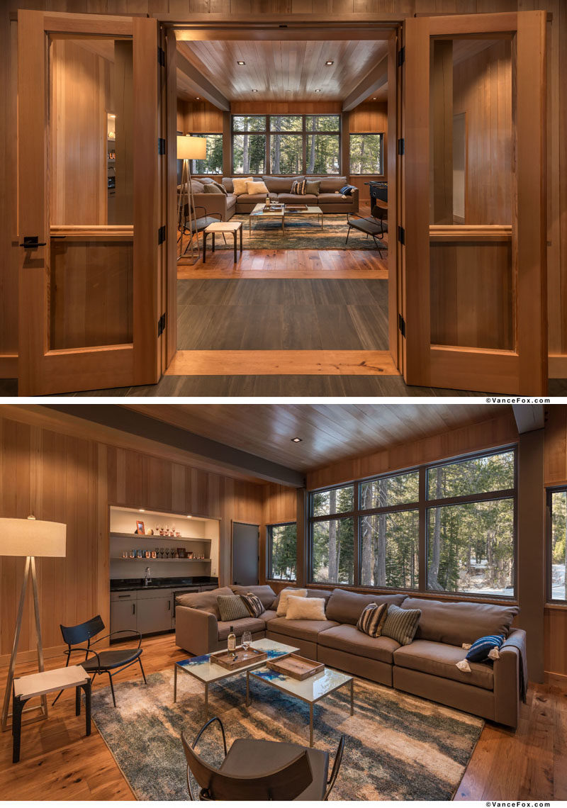 This modern mountain house has a large family room with a wet bar and forest views.  #FamilyRoom #WetBar