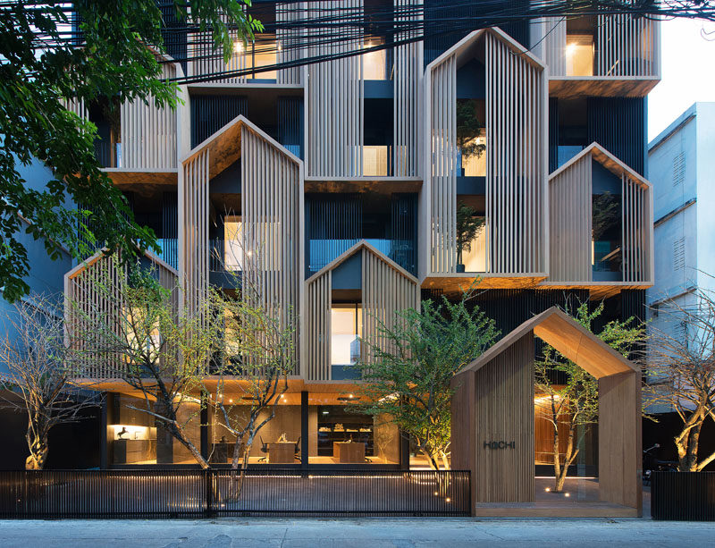 Modular gabled sections made from wood cover the facade of this modern apartment building in Bangkok, Thailand. #Architecture #Facade #ModernBuilding