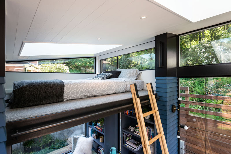 This modern backyard studio (reading retreat) has a collapsible ladder that provides access to a loft bed. #LoftBed #BackyardStudio #BackyardRetreat