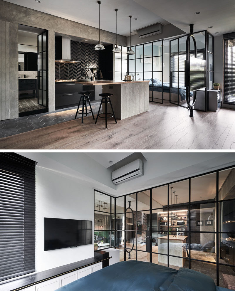 Separated by a black-framed glass wall, this modern bedroom takes advantage of the natural light from the window, which can also filter through to the kitchen. #Bedroom #GlassWall #ModernBedroom #InteriorDesign