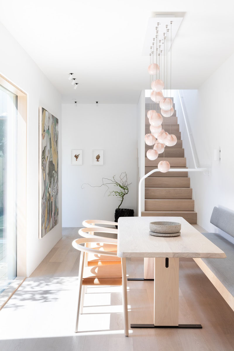 This modern dining area, which has a view of a small courtyard, has built-in banquette seating. #DiningRoom #ModernInterior