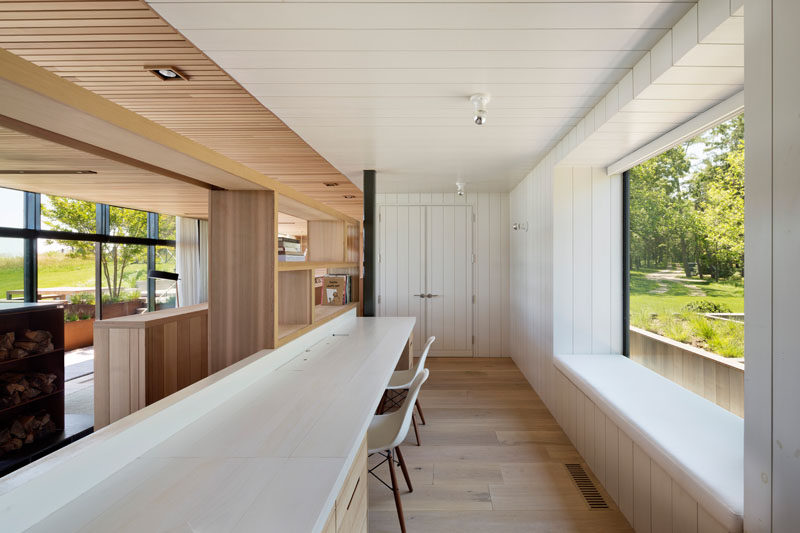 This modern home office with a long desk, overlooks the living room, while a window seat looks out towards the front garden. #HomeOffice #WindowSeat #LongDesk