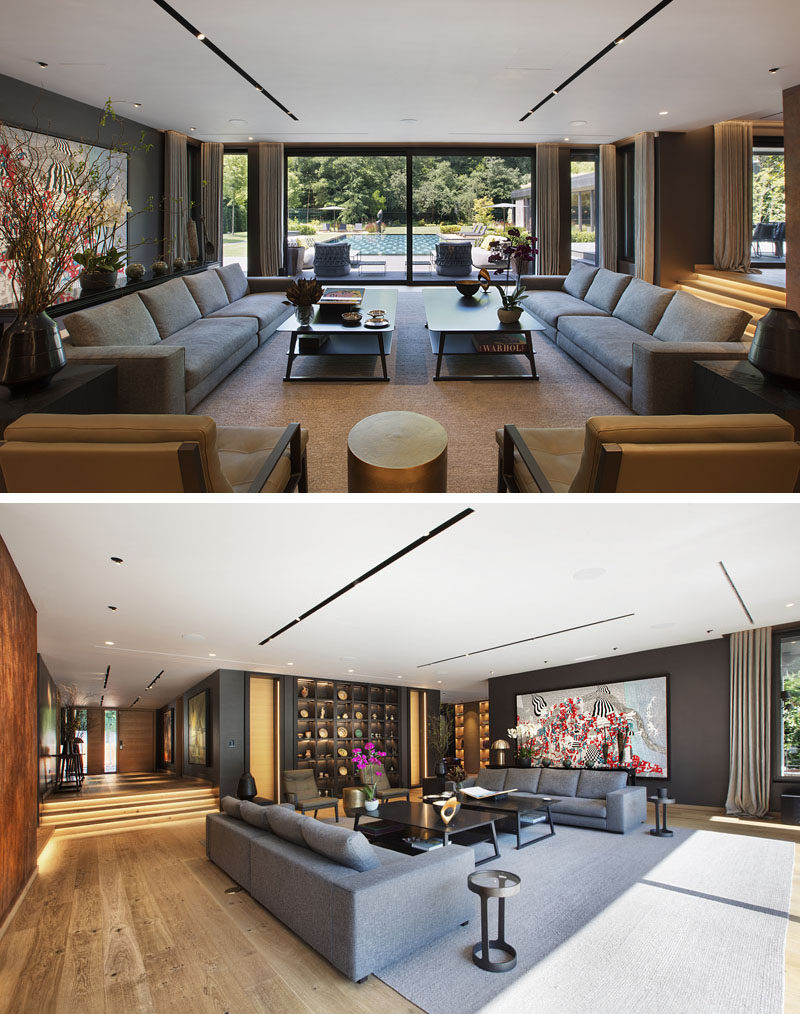 This modern living room looks out towards to the backyard, and a large bookshelf has been built-into the adjacent wall. #LivingRoom #LivingRoomLayout #Shelving