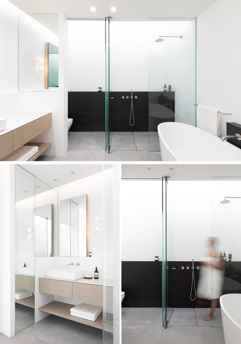 In this modern master ensuite bathroom, there's a skylight above the shower that creates a soft diffused light, while black elements contrast the mostly white room. #Bathroom #BathroomDesign #ModernBathroom