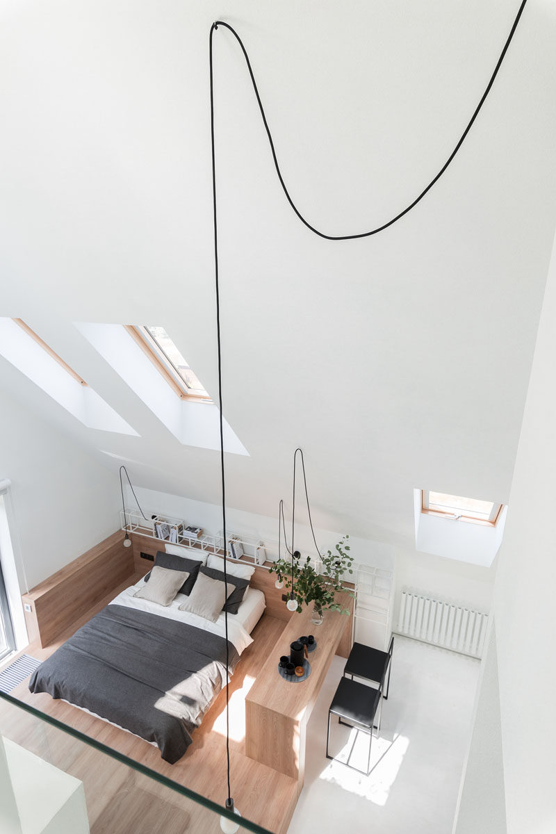 Architecture and interior design firm Ruetemple, have transformed the attic of a house in Moscow, Russia, and made it into a private and relaxing modern bedroom suite with a mezzanine home office. #Bedroom #Attic #HomeOffice #Fireplace #ModernBedroom