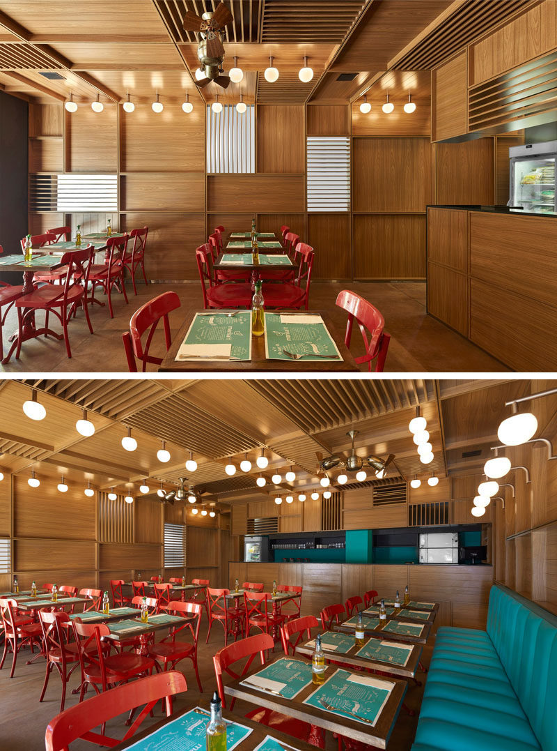 In this modern restaurant, red chairs have been used to add color, and the lighting, designed by the architect, along with Gerbar brass fans, feature on the ceiling. #RestaurantDesign #ModernRestaurant