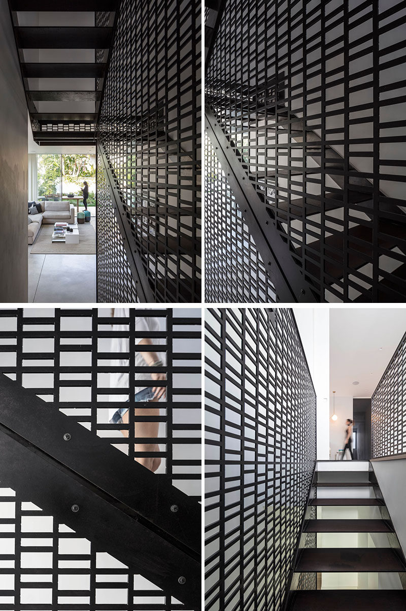 A modern black patterned screen has been used in the stairwell to connect the various floors of the home. #BlackScreen #PatternedScreen #ModernScreen #BlackStairs #StairDesign #ModernStairs