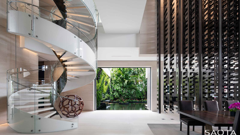 This modern house has a white spiral staircase that leads to the private areas of the house upstairs. #SpiralStaircase #ModernSpiralStaircase #Stairs