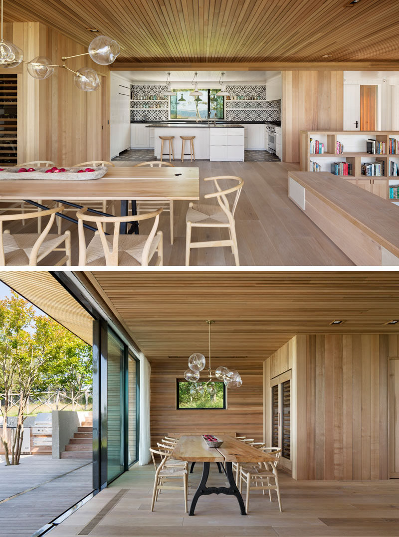 This modern dining room features a built-in wine storage area, and a sliding glass door opens to the terraced deck outside.#DiningRoom #WoodInterior #SlidingGlassDoor