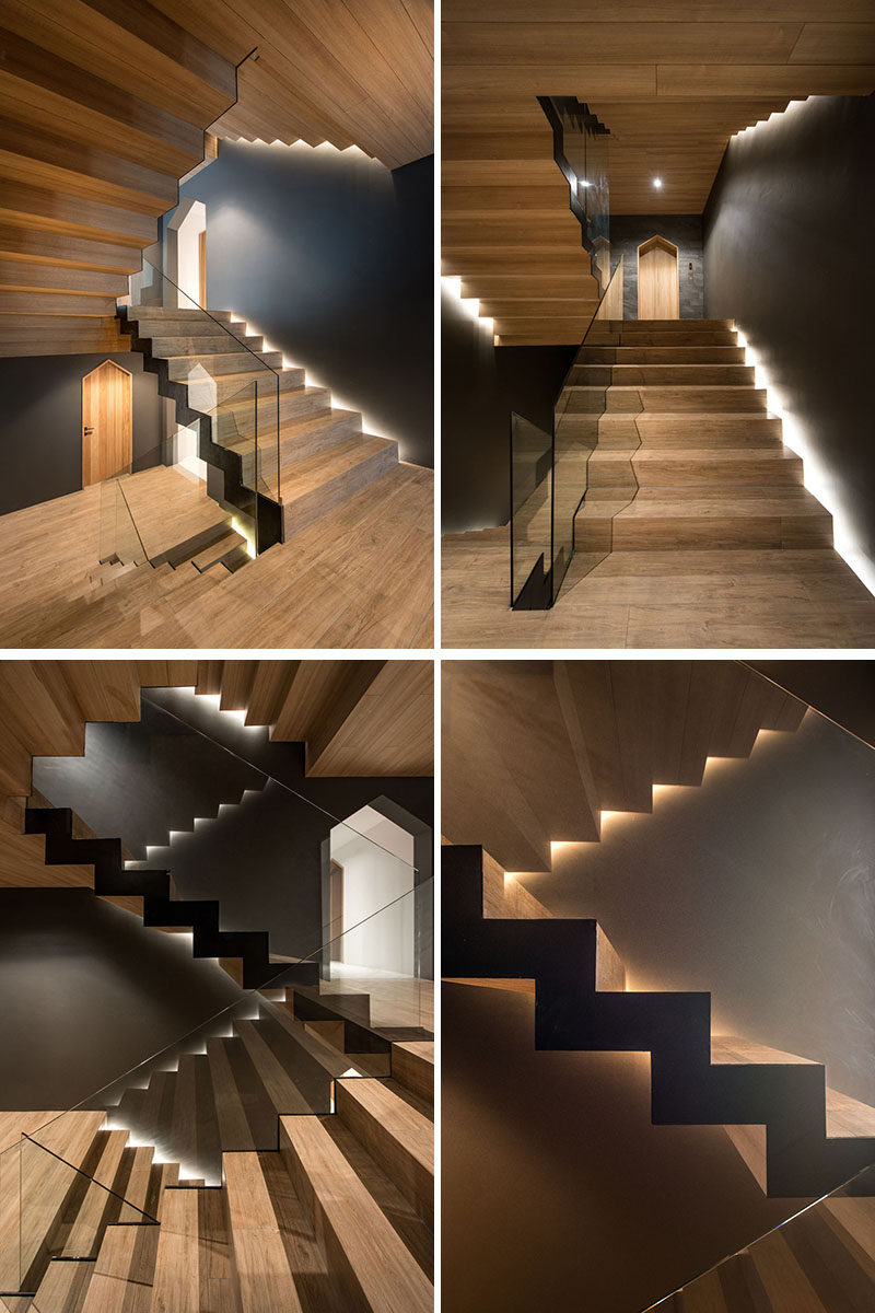 In this modern apartment building, wood stairs have been combined with glass handrails, while hidden lighting showcases the design. #Stairs #ModernStairs #WoodStairs #HiddenLighting