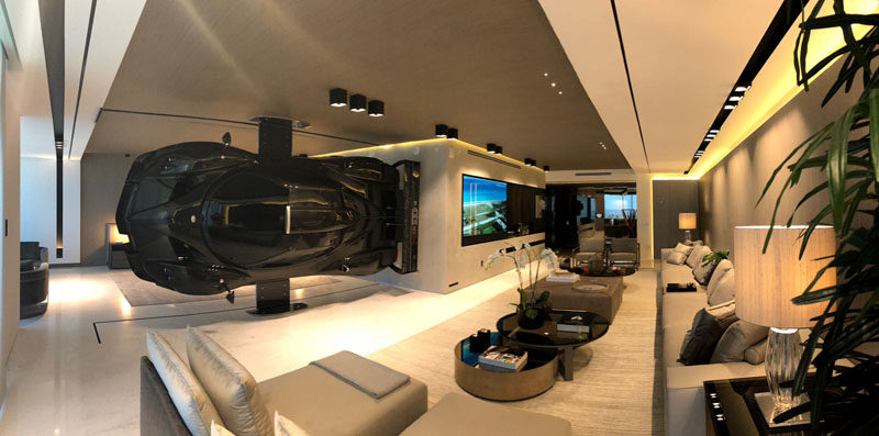 This modern oceanfront condo in Miami has a Pagani Zonda R racing car installed as part of the decor, that serves as a high-impact partition between the living room and master suite. #RacingCar #RoomDivider #ModernInterior