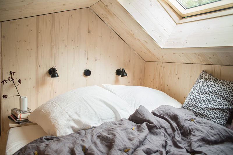 The bedroom in this tiny home has a king size bed that's positioned to look out towards the stars through the skylight. #Bedroom #TinyHome #Skylight