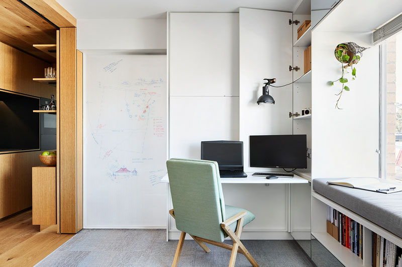 In this small apartment, a sliding door with a whiteboard on one side, can be closed to hide the bedroom from view. #Whiteboard #WhiteboardDoor #HomeOffice