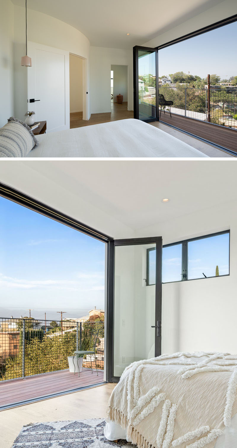 This modern bedroom has folding glass doors that open up to a balcony for picturesque views of the valley. #Bedroom #FoldingGlassDoors #Balcony