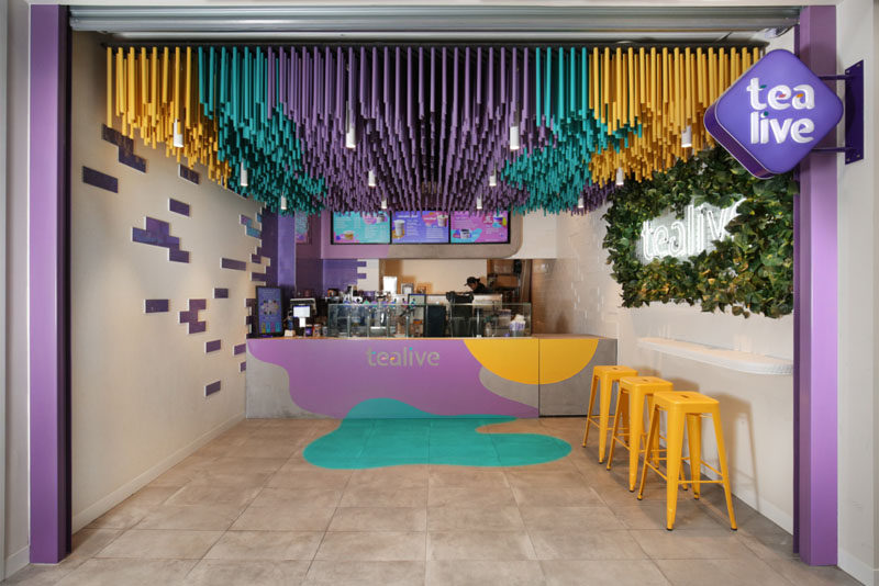 FRETARD Design have completed a bubble tea store that features a colorful dowel accent ceiling and a partial green wall around a neon light. #InteriorDesign #RetailDesign