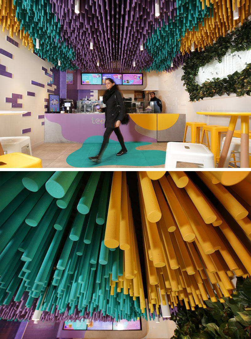 FRETARD Design have completed a bubble tea store that features a colorful dowel accent ceiling and a partial green wall around a neon light. #InteriorDesign #RetailDesign