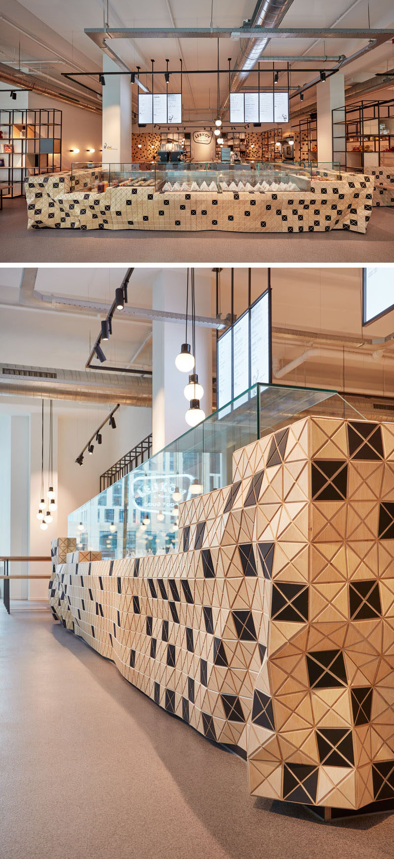 Stepping inside, the bar and the open kitchen of this modern cafe form the centerpiece that organizes and structures the entire café space. The wood-skin has been used to create the sense of movement, and a unique almost-organic shape to the bar and walls. #WoodSkin #CafeDesign #CoffeeShopDesign #InteriorDesign