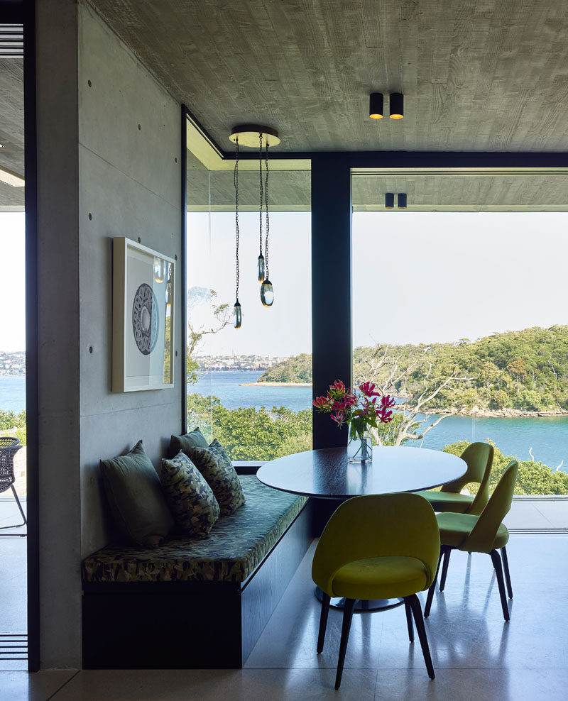 This casual dining area is positioned in front of the windows to take advantage of the water views. #Dining #Windows