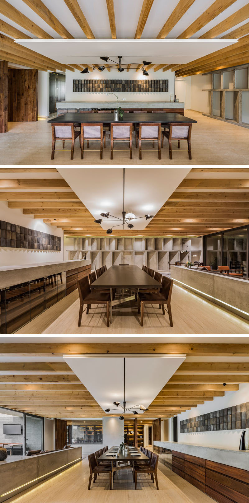 Separated from the living room by a concrete pony wall with embedded lighting, is the main dining area of this modern apartment. A large table fills the open space, while a custom-built concrete and wood sideboard runs alongside it. #DiningRoom #PonyWall #ModernApartment