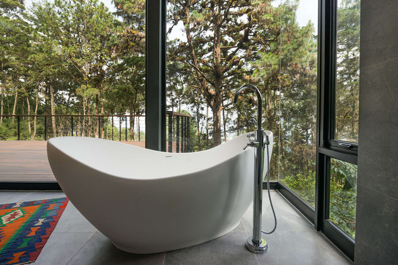 This freestanding bathtub is positioned to take advantage of the tree views. #Bathroom #FreestandingBathtub