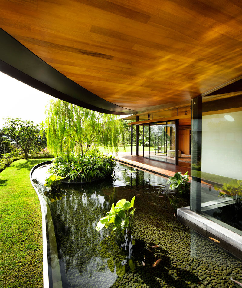 To maximize the indoor/outdoor experience, there's plenty of landscaped areas with grassy lawns, stone pavers, and water features surrounding this modern house. #Landscaping #WaterFeature #ModernHouse