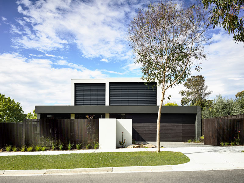The exterior of this modern family house is characterized by simple bold forms offset by expansive glazing and louvre panels. #ModernHouse #ModernArchitecture