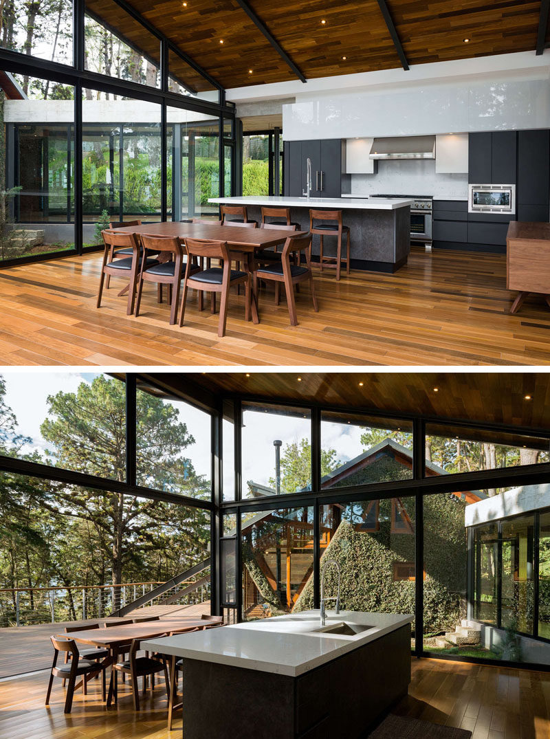 This modern house has plenty of windows that add natural light to the kitchen and dining room. #KitchenDesign #DiningTable