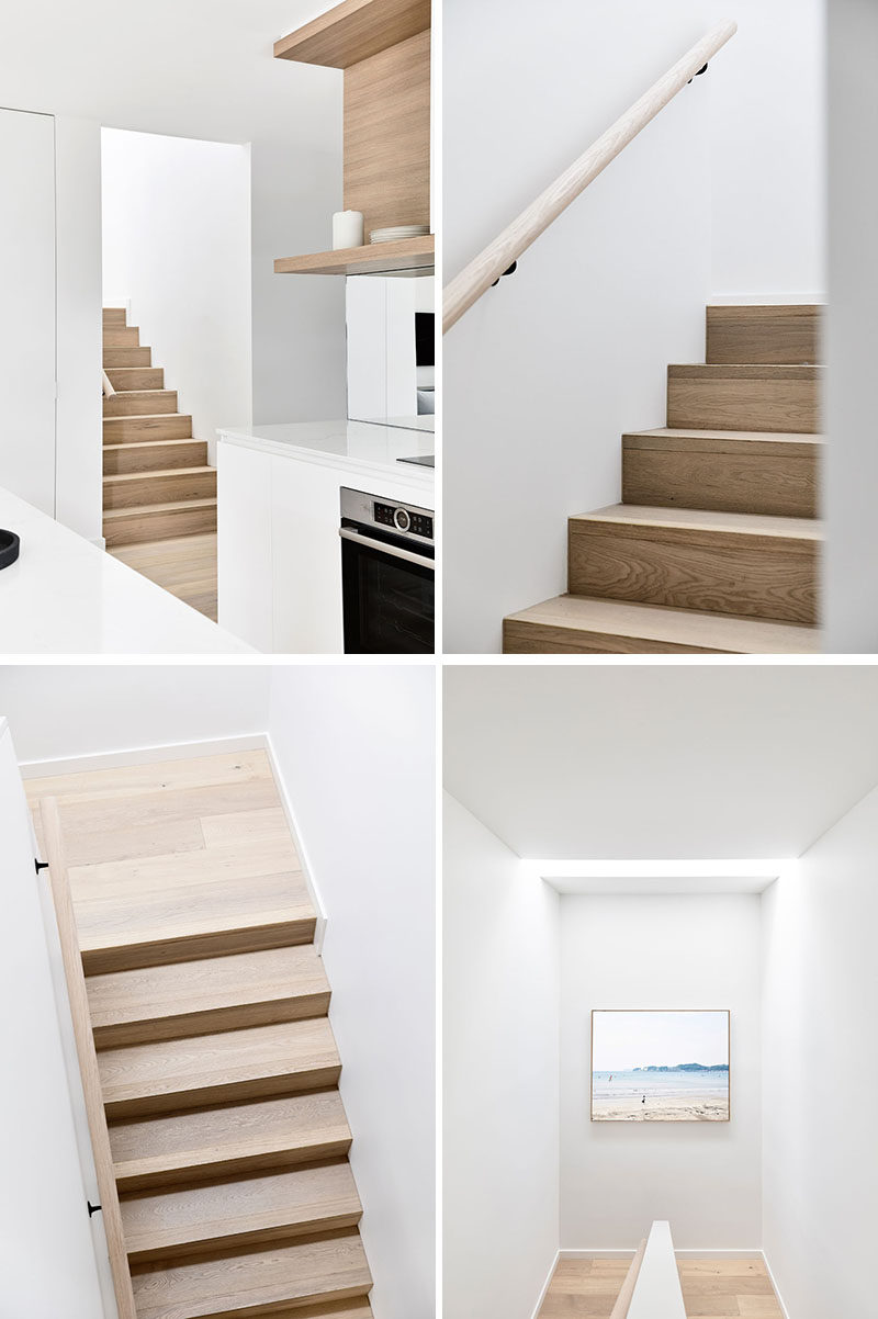 Wood stairs with a matching handrail lead up to the second floor of this modern house, that's home to the private areas, like bedrooms and bathrooms. #WoodStairs #ContemporaryWoodStairs