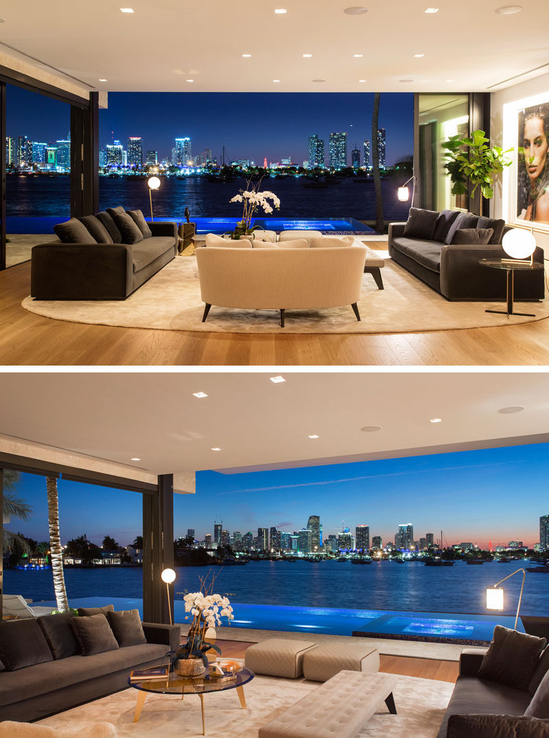 This modern living room is open to the swimming pool deck, and has been positioned to take advantage of the views of Downtown Miami and Biscayne Bay. #LivingRoom #RetractableWalls