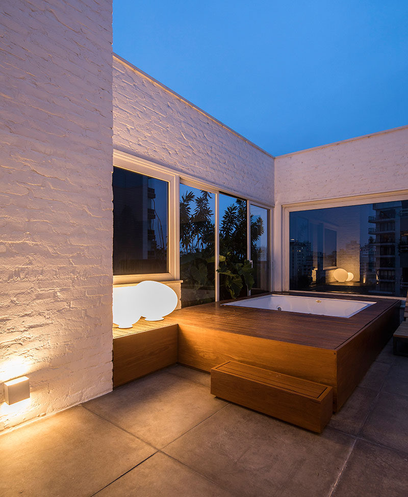 This apartment terrace has a hot tub with a wood surround. #Hottub #Spa