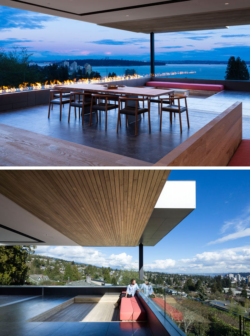 In good weather, the glass walls of this house can be opened to a large covered deck, significantly extending the living area of the house. #ModernHouse #Deck #Fireplace #DiningRoom