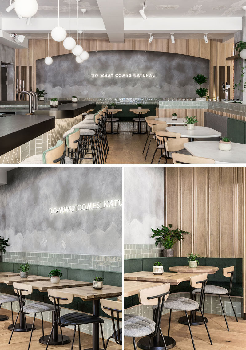 This modern restaurant uses a soft neutral palette with hints of green that complements the rendered concrete walls. #RestaurantDesign #Restaurant