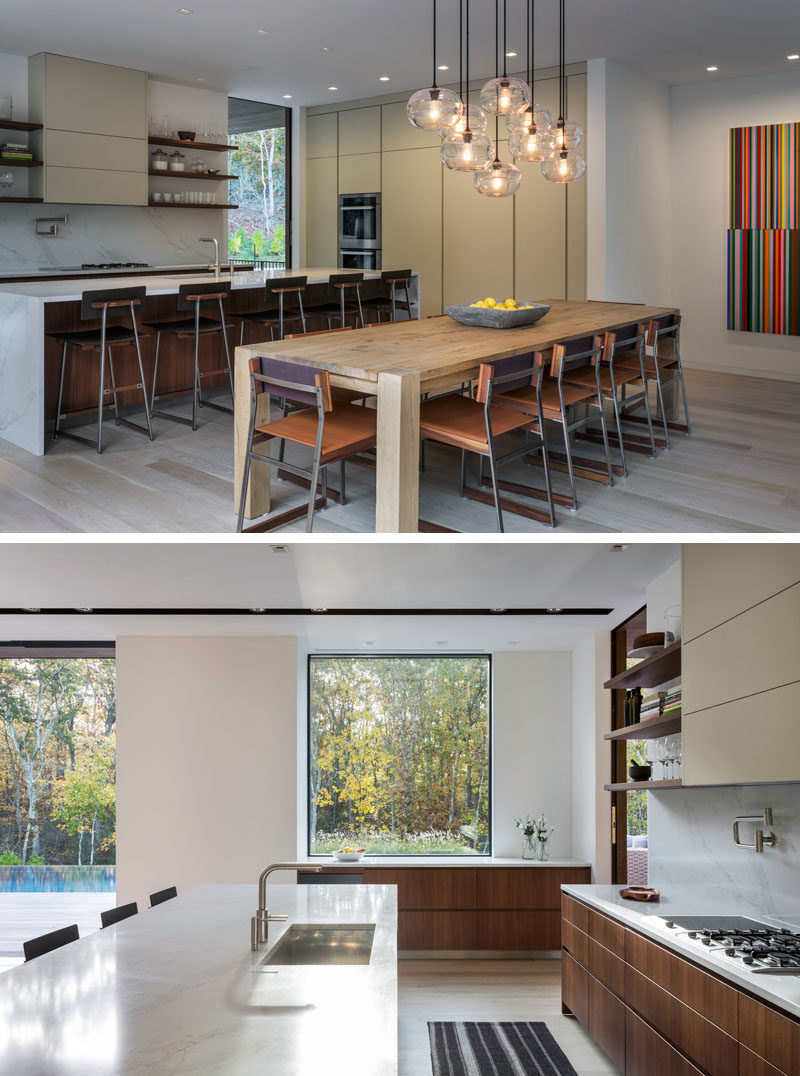 This modern kitchen features open wood shelving that complements the lower wood cabinets. #ModernKitchen #KitchenDesign