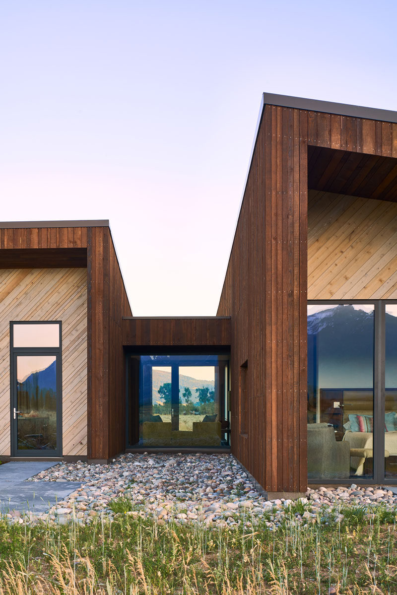 The two-tone exterior of this modern house has been created with the use of rich dark-brown vertical Douglas Fir and lighter horizontal Cedar, allowing the home to meld into the native woody sage-brush surrounding the home. #WoodHouse #WoodCladding #WoodSiding #ModernHouse #Architecture