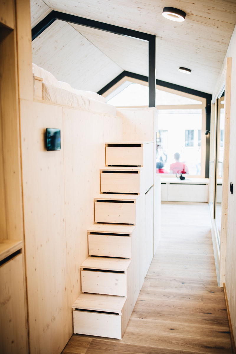 In this tiny home, the stairs leading up to the lofted bed, have built-in storage. #Stairs #StairsWithStorage #TinyHome