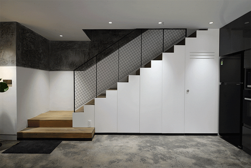 Minimal Design created a staircase with plenty of storage underneath, and a powder room. #Stairs #StairsWithStorage #UnderStairStorage #UnderstaorBathroom