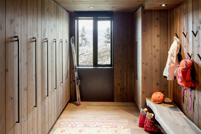 This modern mountain chalet features a dry/wet room with plenty of space for hanging coats and storing equipment. #InteriorDesign #DryRoom #WetRoom #Mudroom