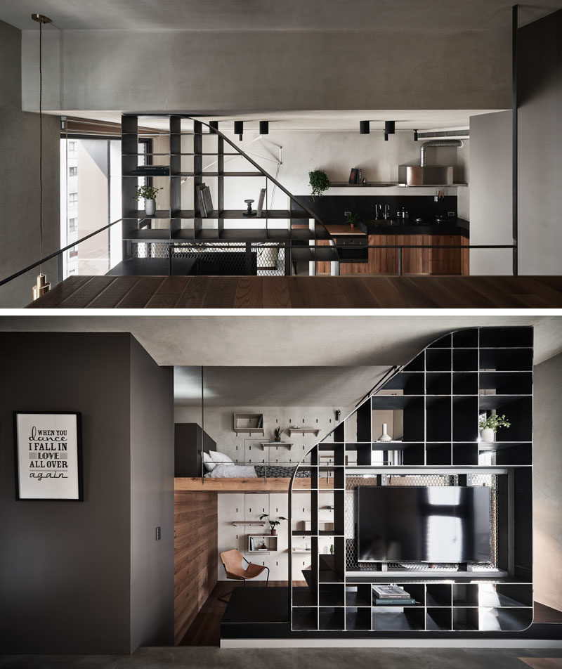 This modern apartment has a mezzanine bedroom, and beside the bed, another pegboard wall has been added, creating the illusion that it continues through to both levels. #ApartmentDesign #ModernApartment #MezzanineBedroom