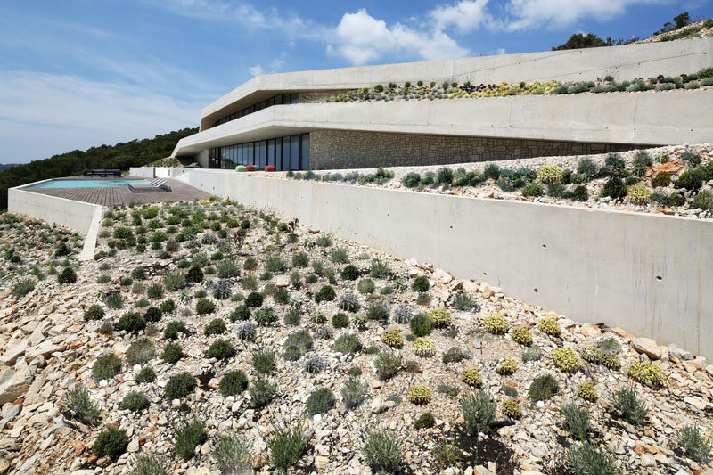 Proarh have recently completed Issa Megaron, a modern concrete house that's been designed for family retreats, and is dug into the hillside of Vis Island, Croatia. #ModernHouse #ModernArchitecture