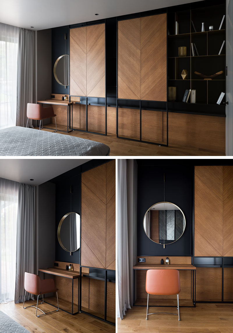 This modern bedroom has a custom shelving unit with sliding wood panels that can be opened to reveal the television, or closed to highlight the open shelving and vanity on either side. #Modernbedroom #ShelvingUnit #HideTV