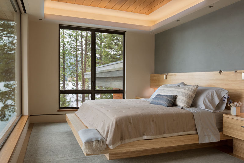 This contemporary guest bedroom has a custom-built wood bed frame to save on space. #BedroomDesign #BedFrame