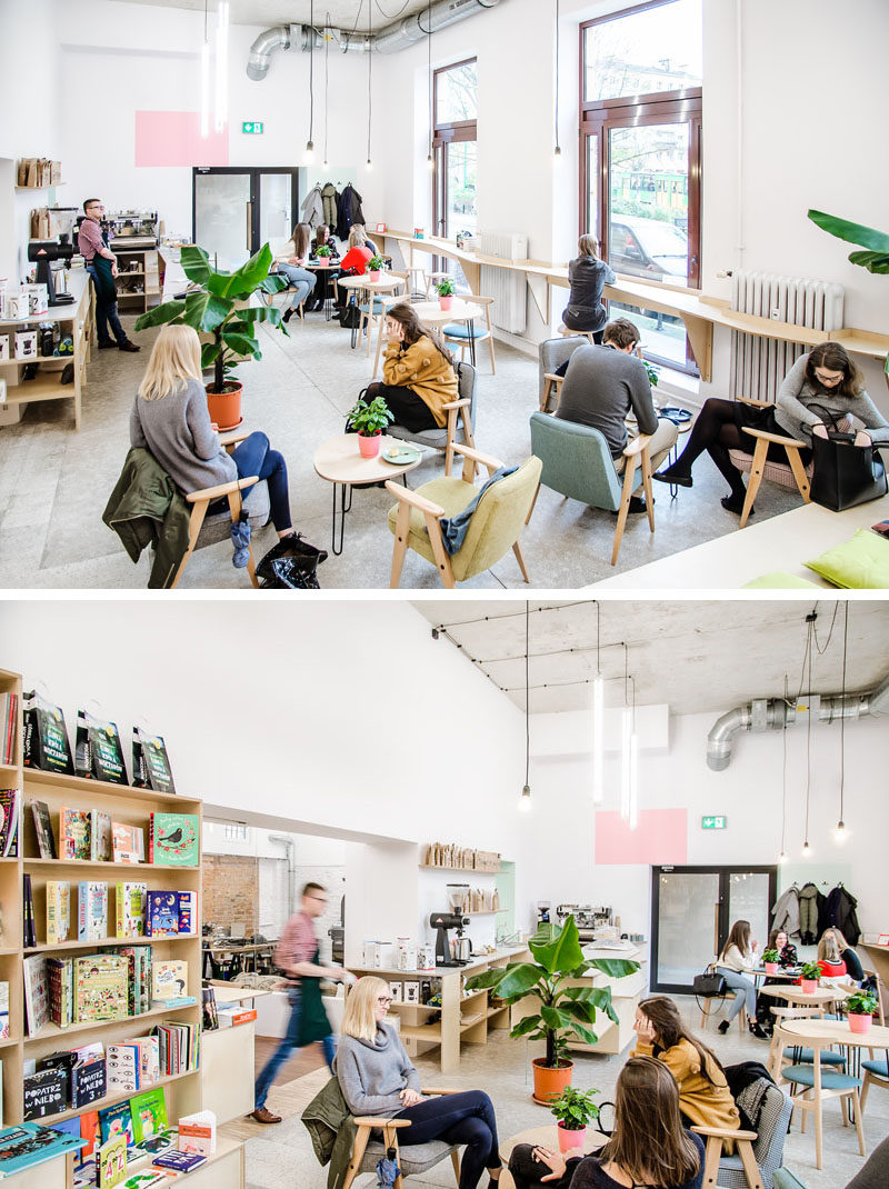 This modern coffee house has light wood bar stools that run alongside the windows that look out onto the street, while armchairs and low tables fill the open space. #CoffeeShop #CoffeeHouse #Cafe #InteriorDesign