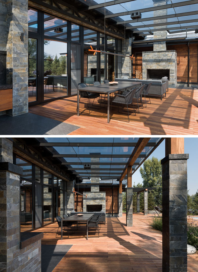 This modern house has a covered patio with an outdoor dining area, a lounge and a stone-clad fireplace. #Patio #CoveredPatio #OutdoorSpace #Fireplace