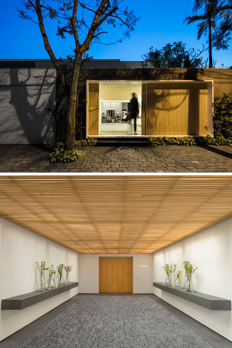 A wood front door with entrance hall welcomes people to this modern house and guides them inside. #WoodFrontDoor #EntranceHallway