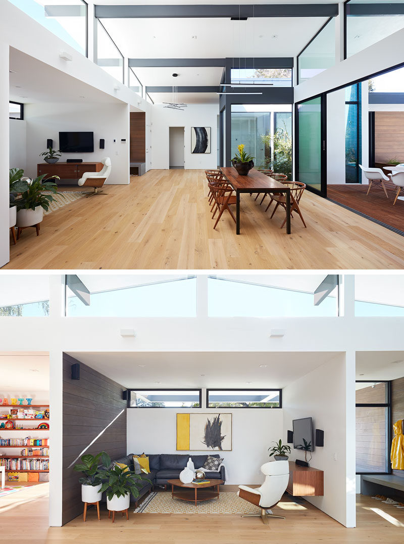 A palette of white oak floors, white walls, walnut cabinetry, and dark window frames creates a uniform feeling and flow throughout this modern house. #InteriorDesign #ModernHouse #OpenPlan