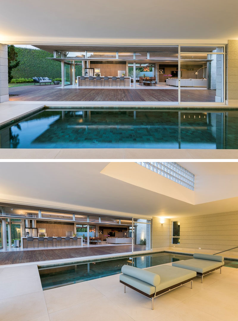 Large sliding glass walls open this modern house annex completely, allowing easy movement between the interior and exterior spaces. #Annex #IndoorPool #SwimmingPool