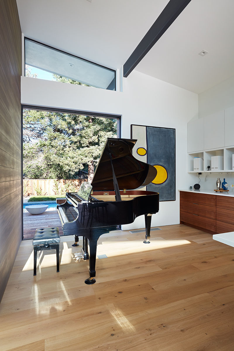 This modern house has a music room that opens to the backyard. #MusicRoom #HighCeilings