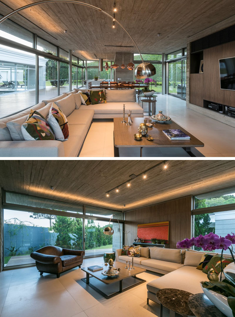 This modern living room features an Italian walnut home theatre and custom design L-shaped lights on the ceiling. #LivingRoom #ConcreteCeiling #Lighting